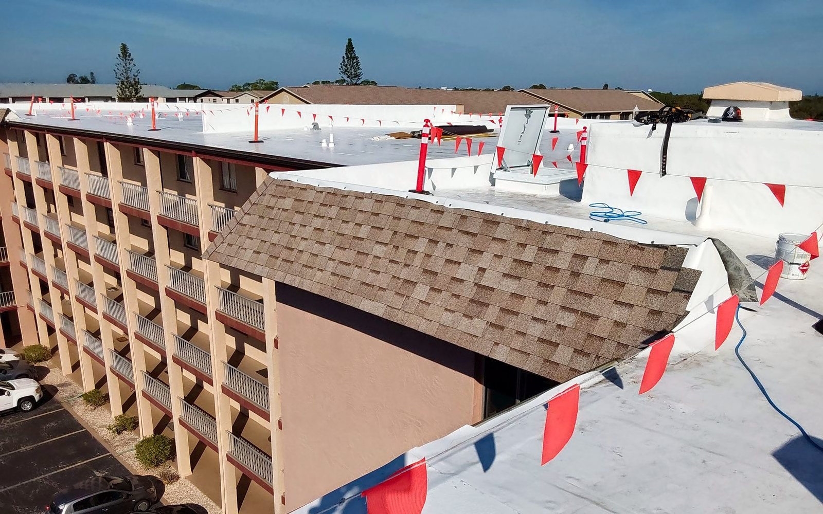 Multi-story commercial building with flat roof sections and a shingled mansard