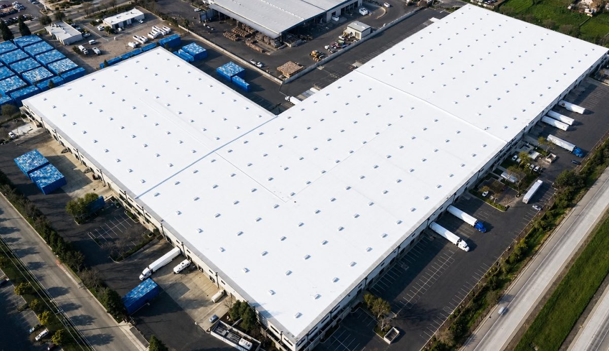 White silicone roof coating on a large commercial roof